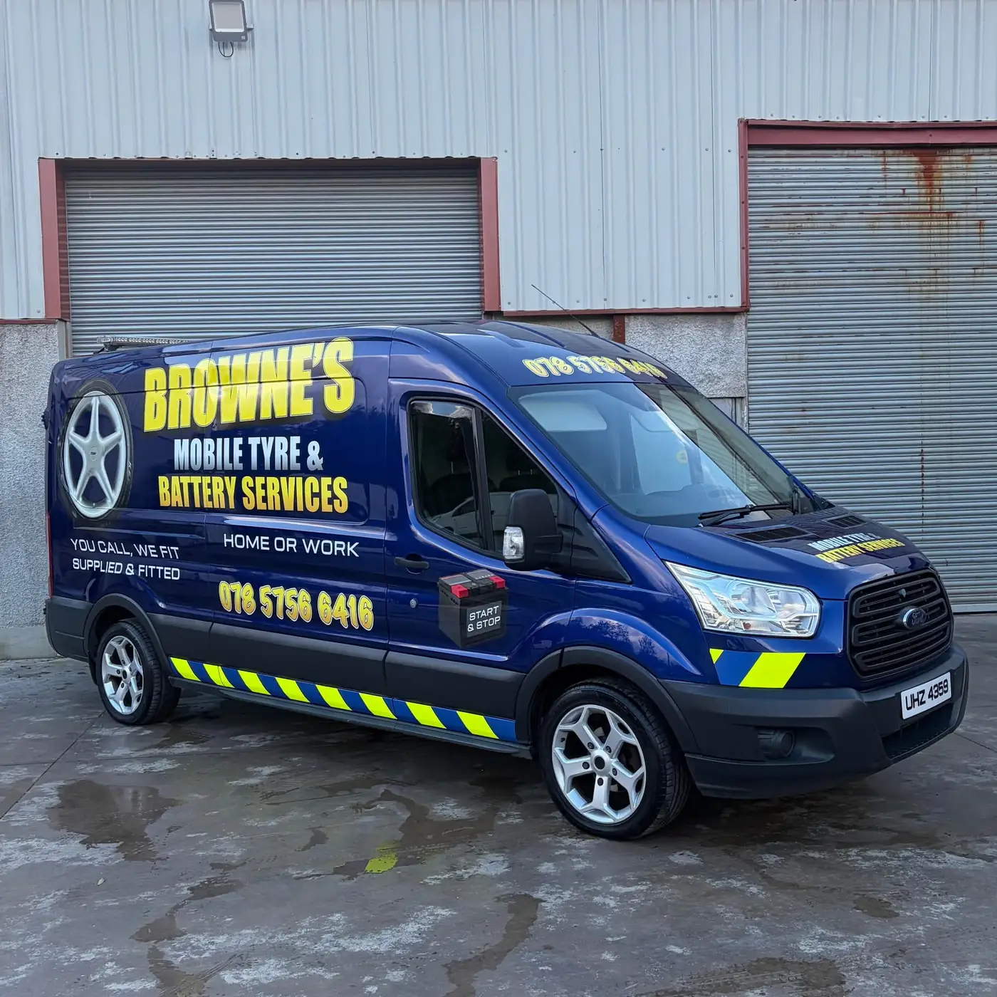 The Browne's van parked on a wet yard in front of grey roller shutters